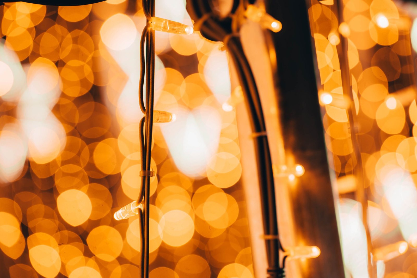 Close-up of glowing string lights with a warm festive bokeh effect